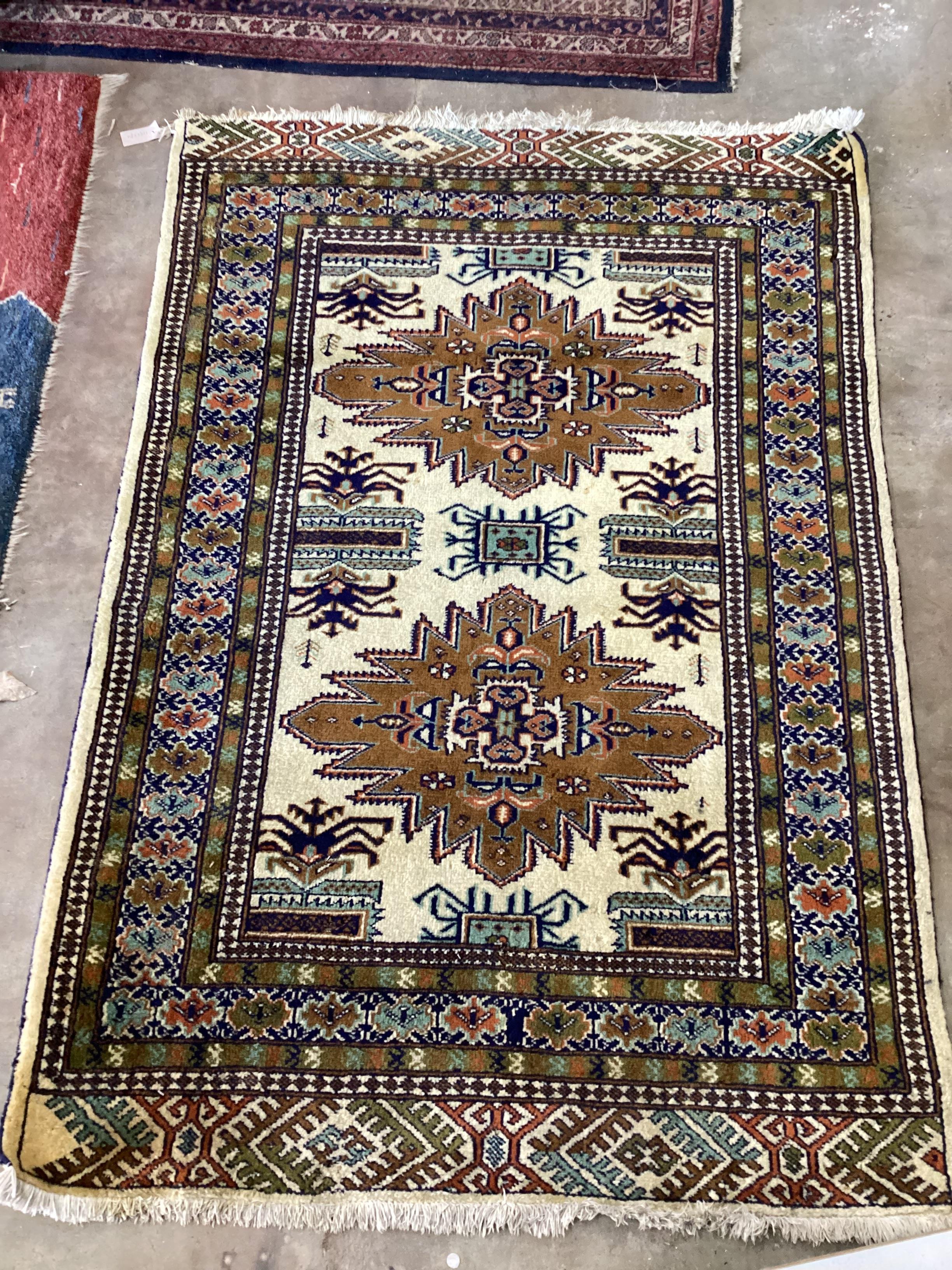 A Turkish ivory ground twin medallion rug, 174cm x 118cm